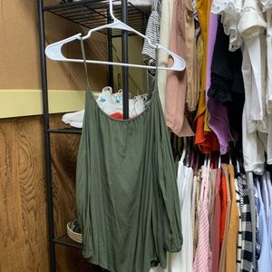 A green off the shoulder shirt